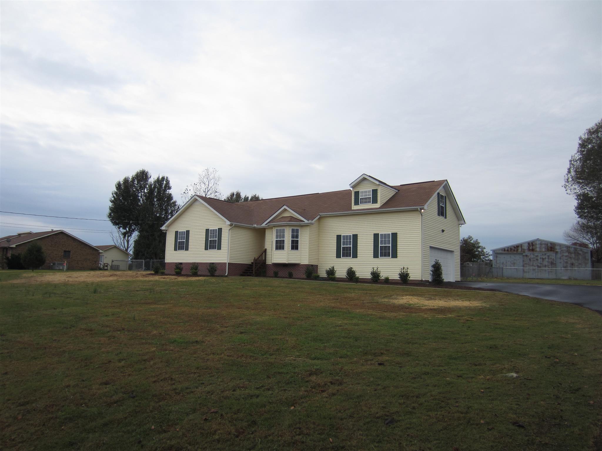 206 Bettis Road Lebanon, TN 37090 - Photo 6 of 21 a house that is sitting in the grass with large trees