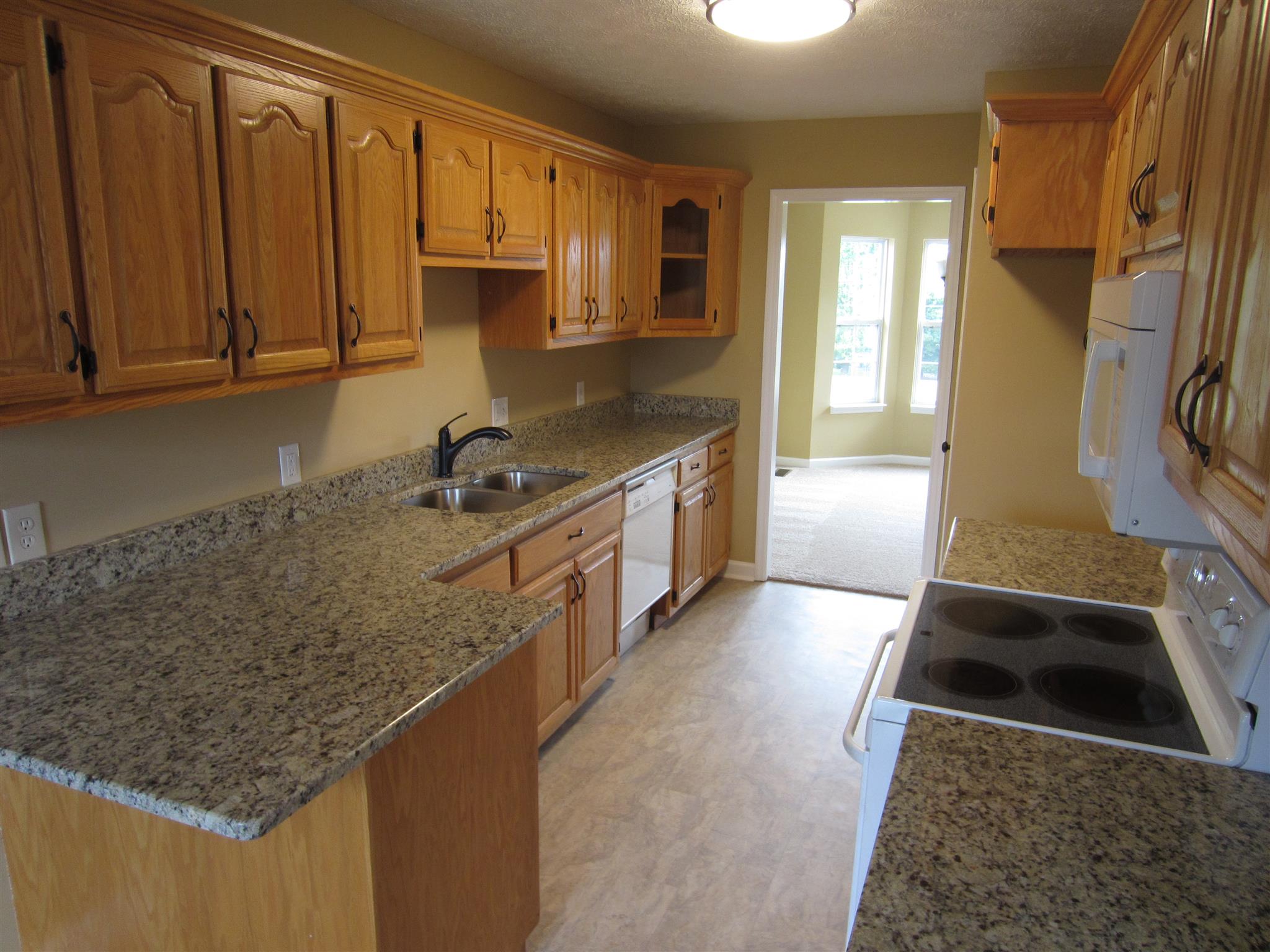 206 Bettis Road Lebanon, TN 37090 - Photo 9 of 21 a kitchen with stainless steel appliances granite countertop a sink stove and refrigerator