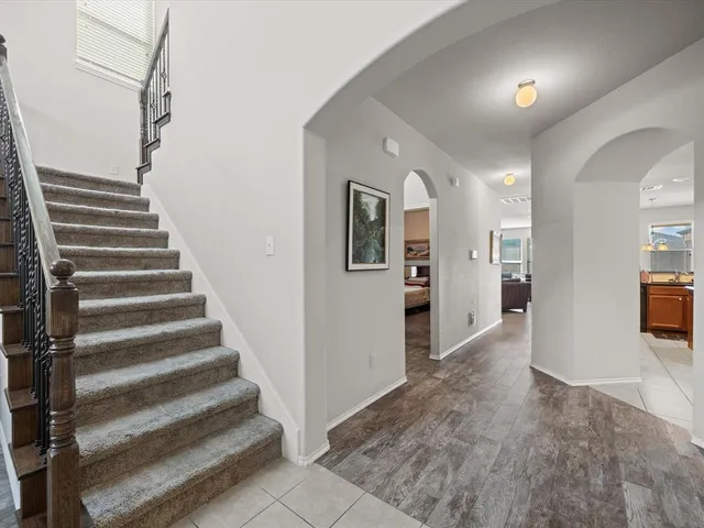 a view of a hallway with wooden floor and entryway
