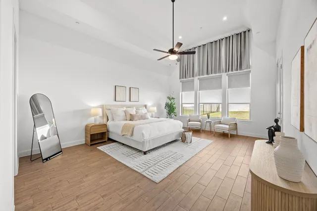 a bedroom with furniture and a large window