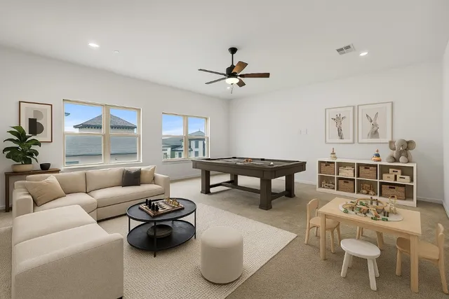a living room with furniture a rug potted plant and a large window