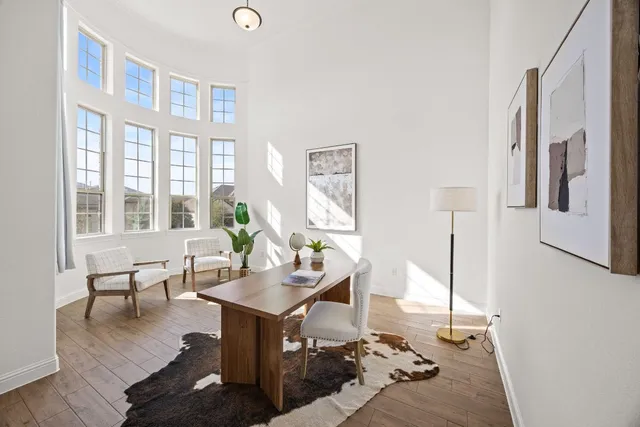 a living room with furniture and floor to ceiling windows