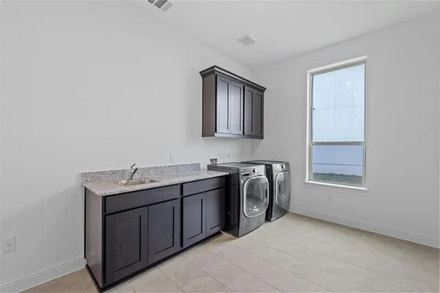 a utility room with a sink a washer and dryer