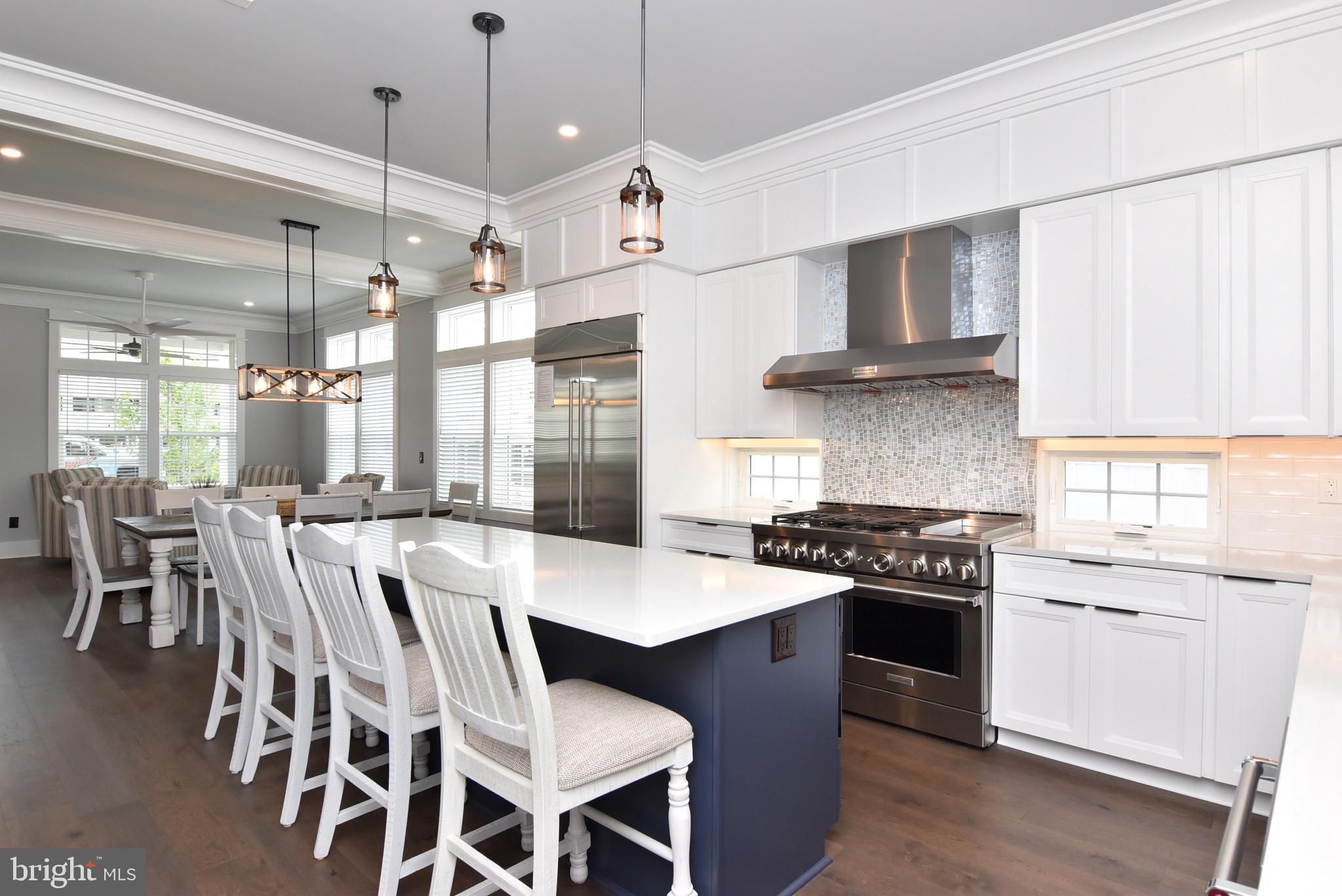 3 Laurel Street Rehoboth Beach, DE 19971 - Photo 11 of 47 a large kitchen with stainless steel appliances stove a table and chairs