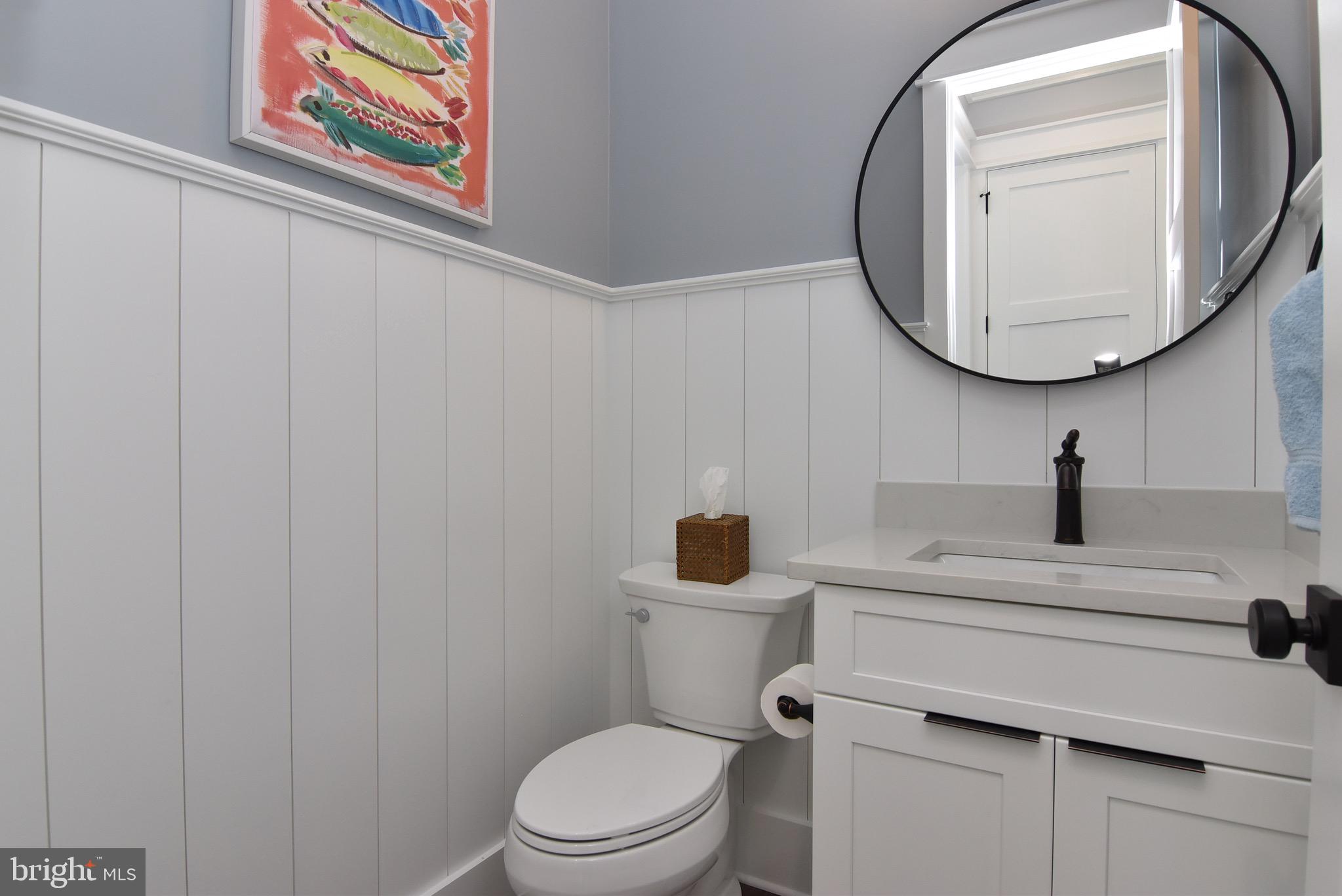 3 Laurel Street Rehoboth Beach, DE 19971 - Photo 18 of 47 a bathroom with a toilet a sink and a mirror
