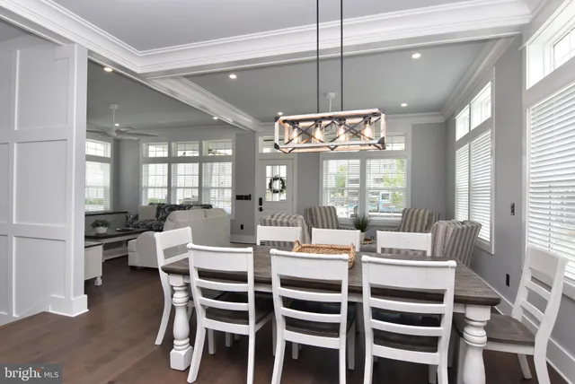 a view of a dining room with furniture wooden floor and chandelier