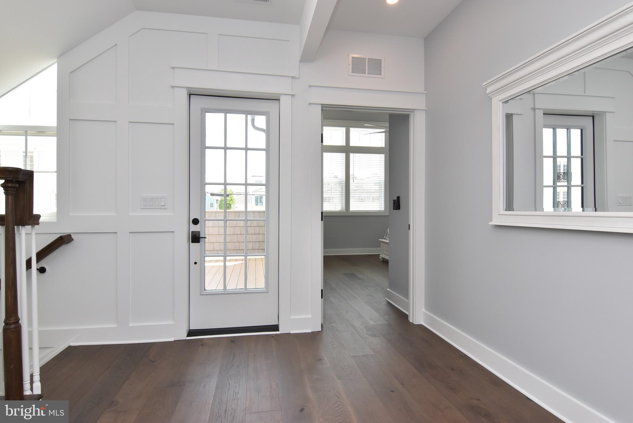 3 Laurel Street Rehoboth Beach, DE 19971 - Photo 22 of 47 an empty room with wooden floor and windows
