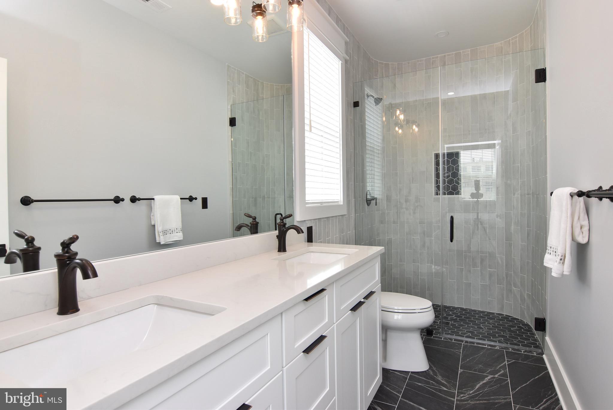 3 Laurel Street Rehoboth Beach, DE 19971 - Photo 25 of 47 a bathroom with a sink a toilet and shower