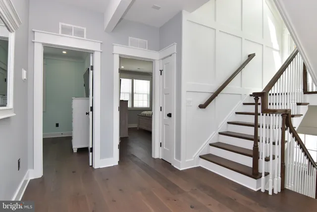 a view of entryway with wooden floor and stairs