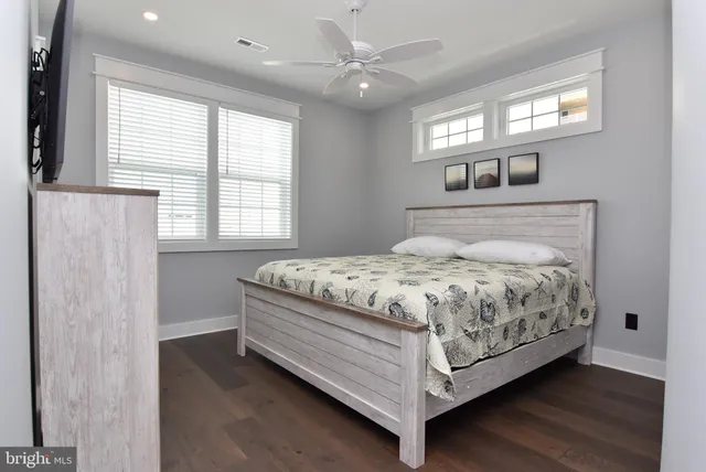 a bedroom with a bed dresser and a window
