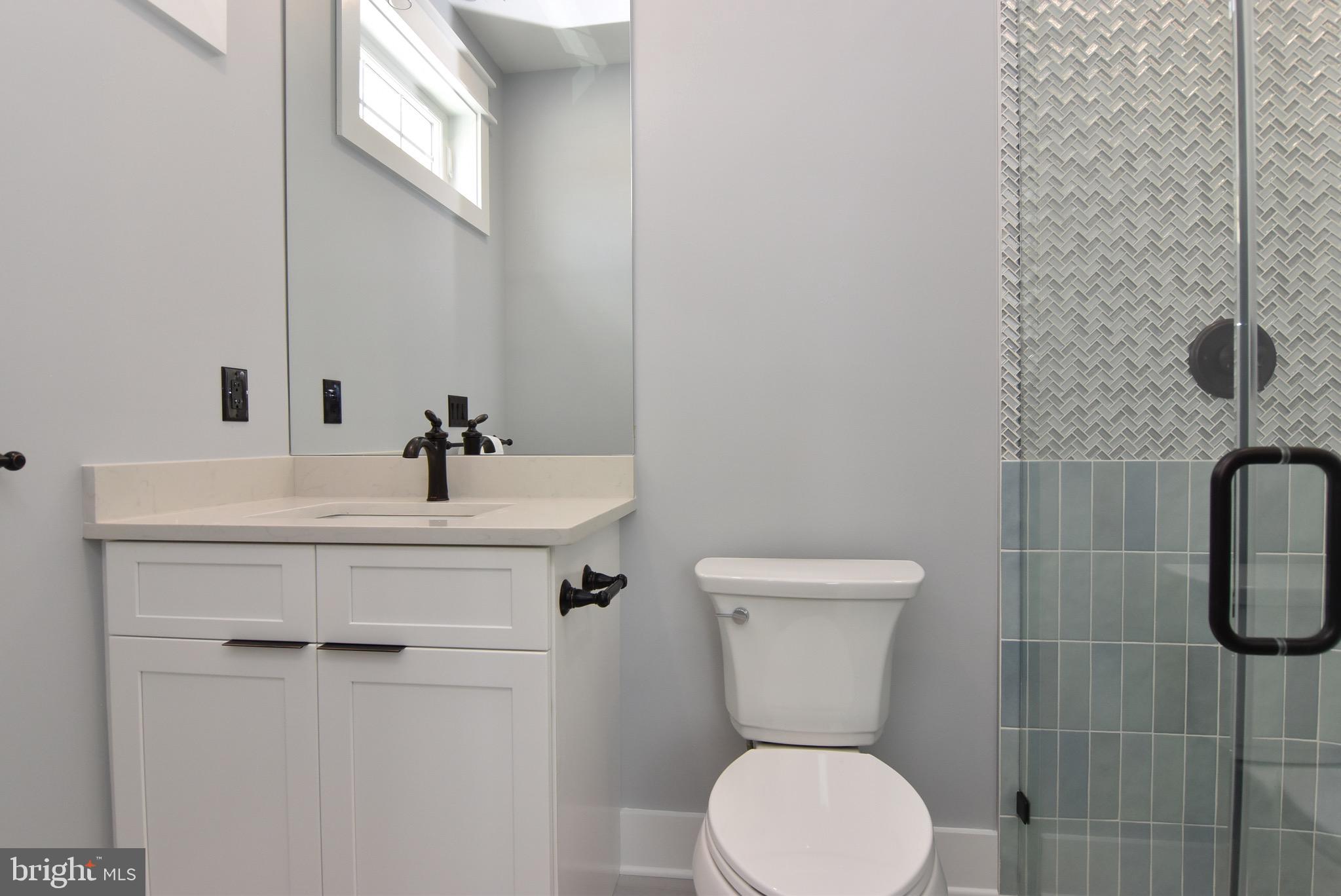 3 Laurel Street Rehoboth Beach, DE 19971 - Photo 30 of 47 a bathroom with a sink toilet and shower