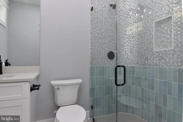 a bathroom with a toilet and a shower