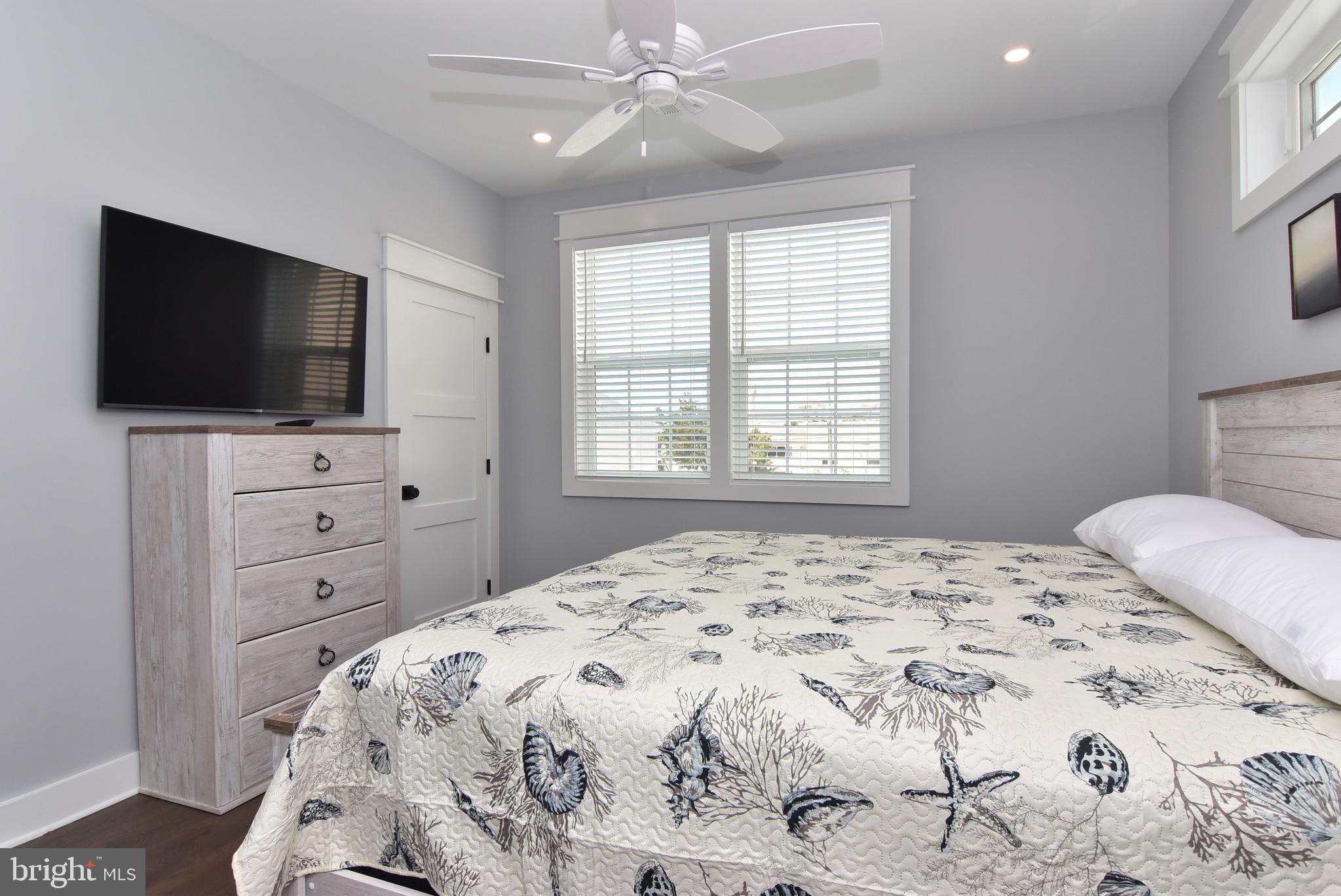 3 Laurel Street Rehoboth Beach, DE 19971 - Photo 32 of 47 a bedroom with a bed and a flat screen tv