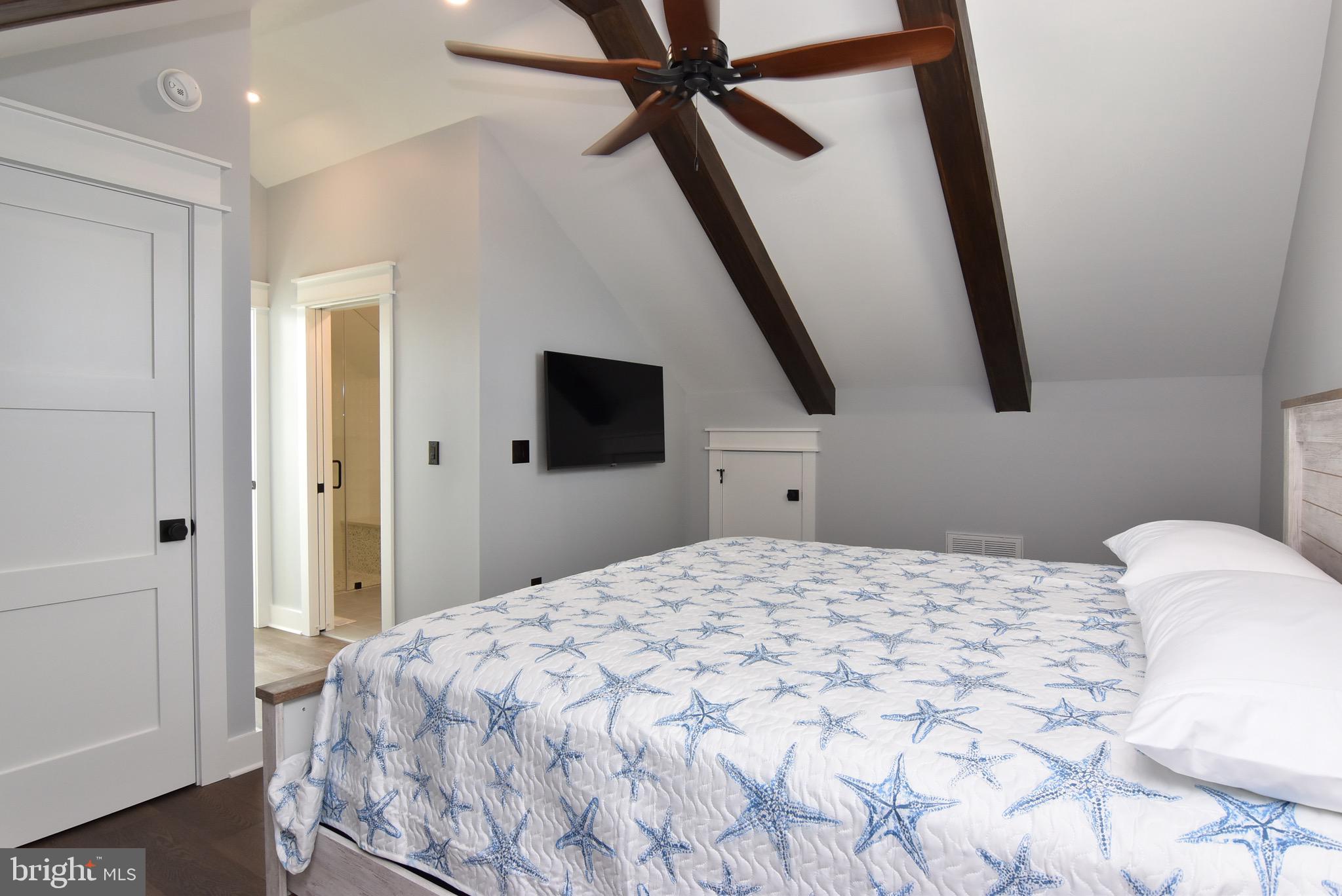 3 Laurel Street Rehoboth Beach, DE 19971 - Photo 37 of 47 a bedroom with a bed and a flat tv screen