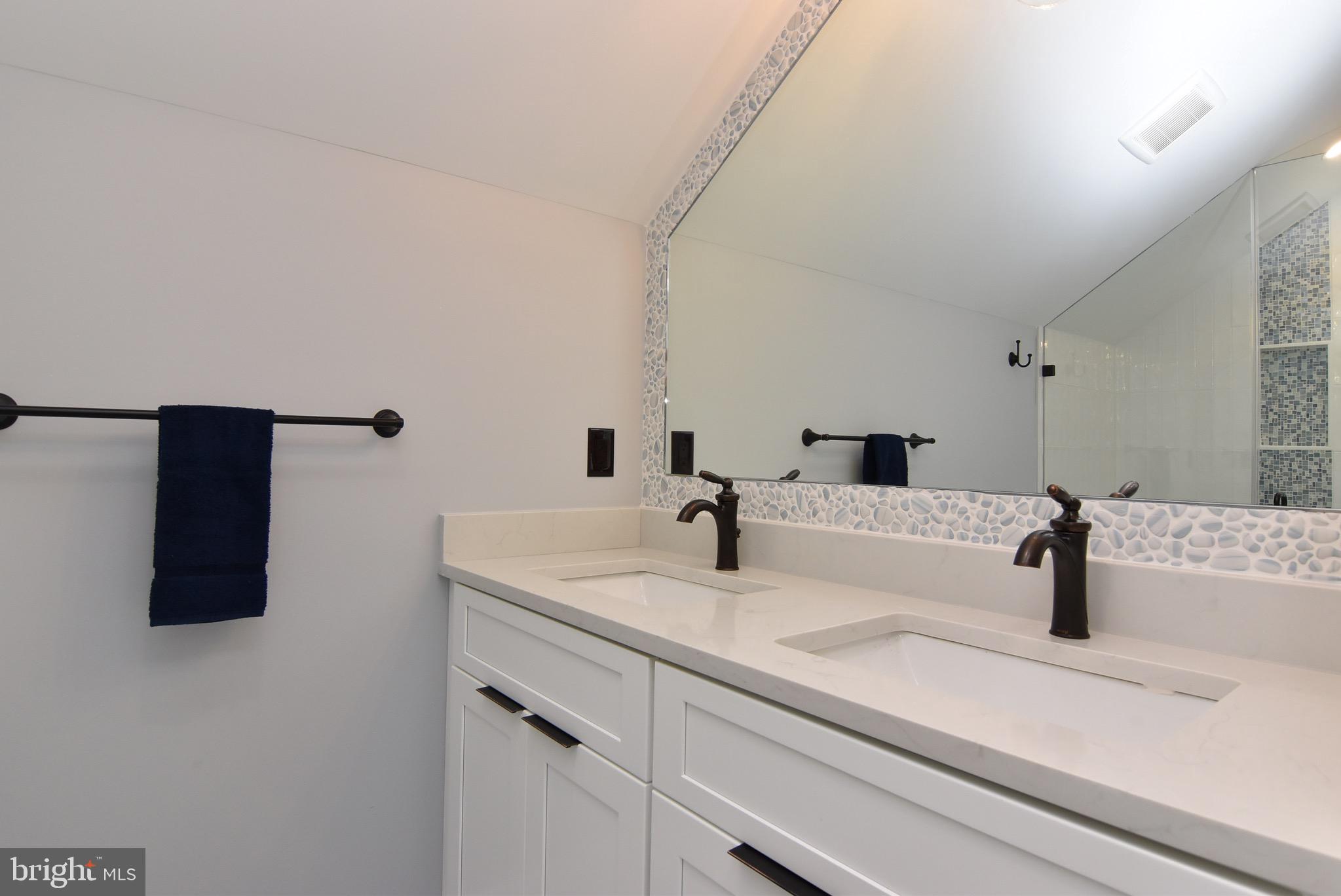 3 Laurel Street Rehoboth Beach, DE 19971 - Photo 40 of 47 a bathroom with a sink and a mirror