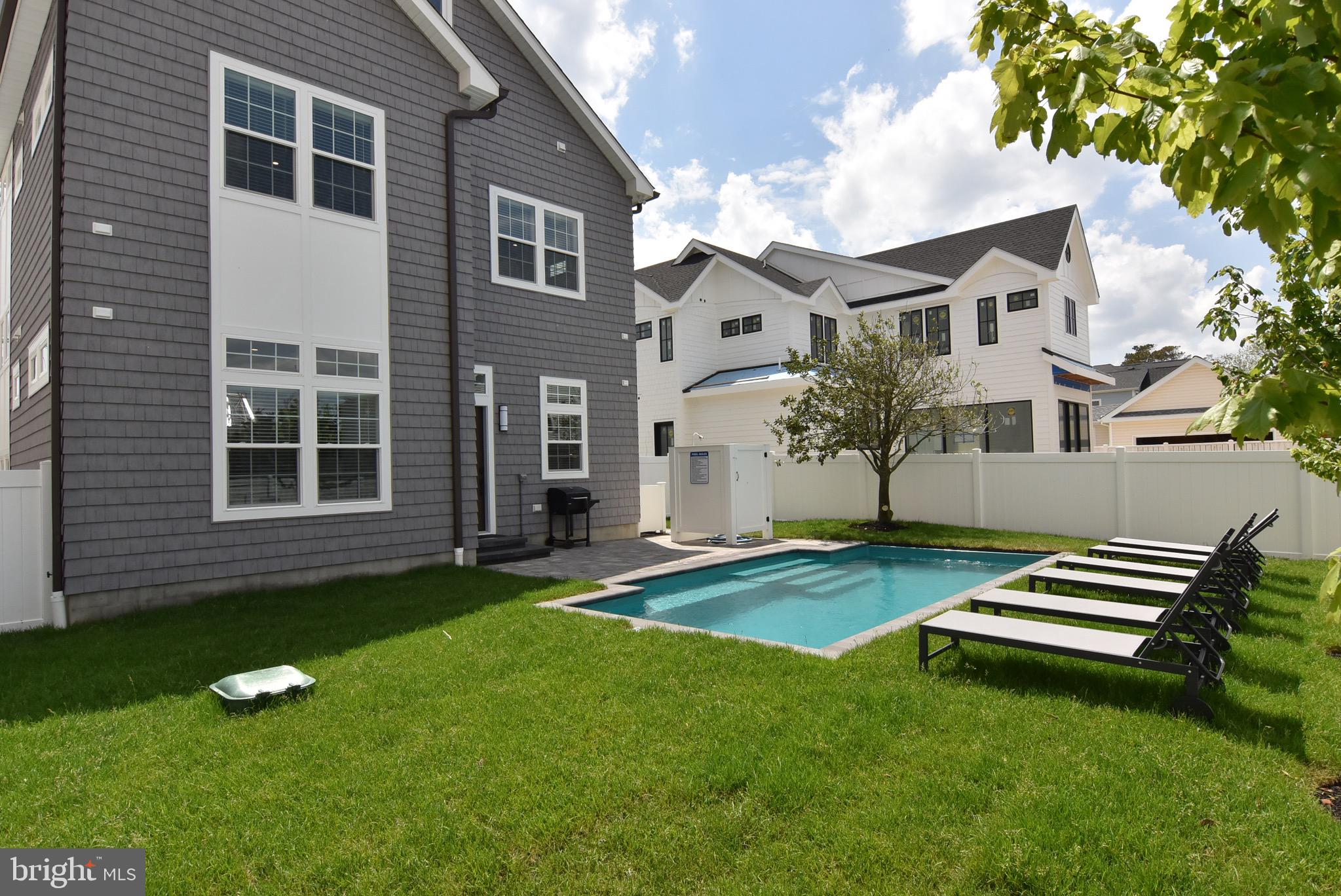 3 Laurel Street Rehoboth Beach, DE 19971 - Photo 4 of 47 a backyard of a house with table and chairs