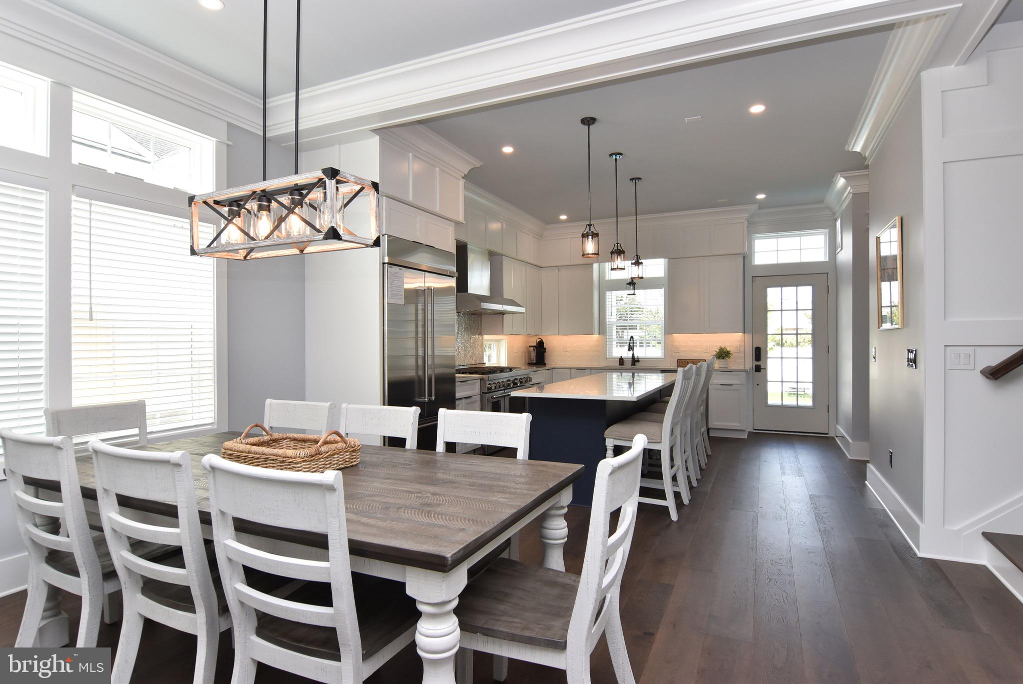 3 Laurel Street Rehoboth Beach, DE 19971 - Photo 9 of 47 a dining room with a table chairs and kitchen view