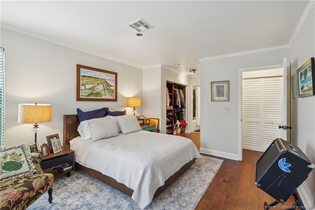 800 Northwest Fork Road, Unit 513 Stuart, FL 34994 - Photo 14 of 30 a bedroom with a bed and wooden floor