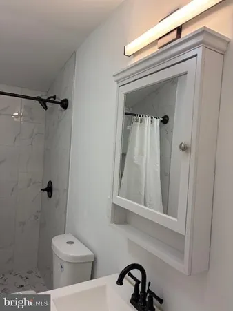 a bathroom with a toilet and a shower