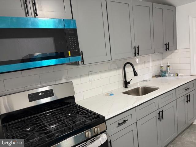 4278 Orchard Street Philadelphia, PA 19124 - Photo 6 of 19 a kitchen with white cabinets and appliances