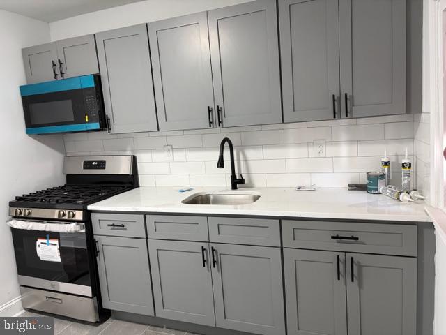 4278 Orchard Street Philadelphia, PA 19124 - Photo 8 of 19 a kitchen with white cabinets and white appliances