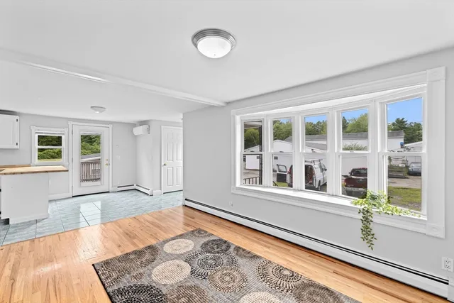 a view of a bedroom with wooden floor and a bed