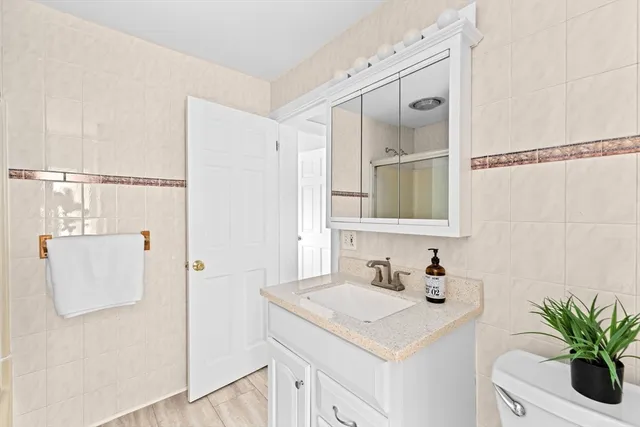 a view of a house with wooden deck and furniture