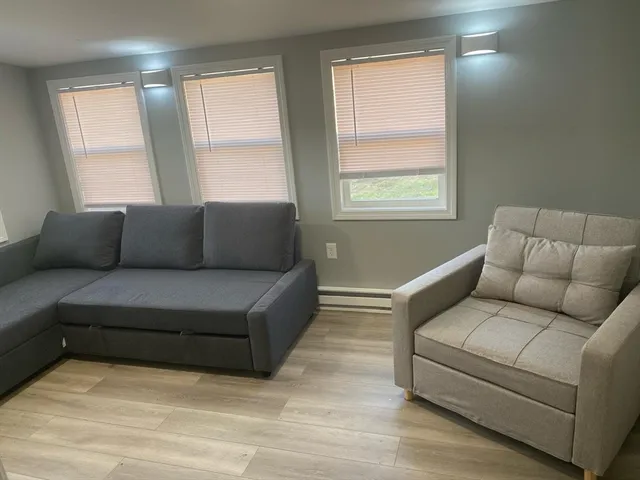a kitchen with granite countertop white cabinets and a stove
