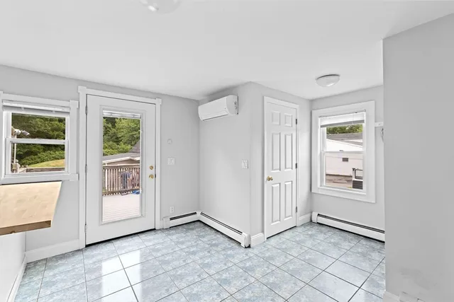 a view of a livingroom with an empty space and a window