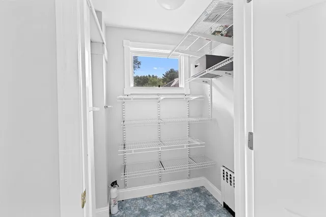 a view of a bedroom with wooden floor and a large window