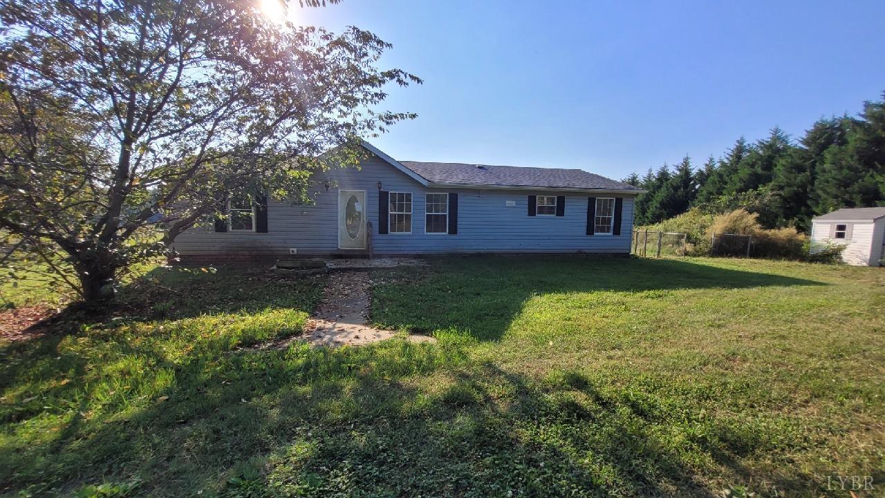 1977 Lyle Thomas Road Spout Spring, VA 24538 - Photo 1 of 11 a house is sitting in middle od the grass