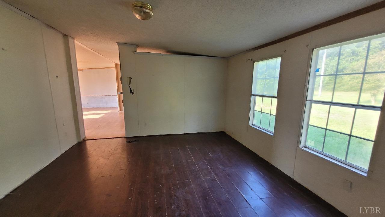 1977 Lyle Thomas Road Spout Spring, VA 24538 - Photo 2 of 11 an empty room with wooden floor and windows