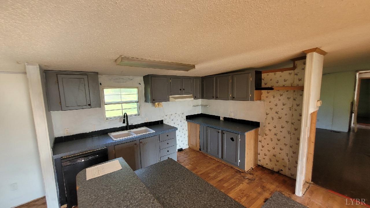 1977 Lyle Thomas Road Spout Spring, VA 24538 - Photo 4 of 11 a kitchen with granite countertop a sink stove and cabinets