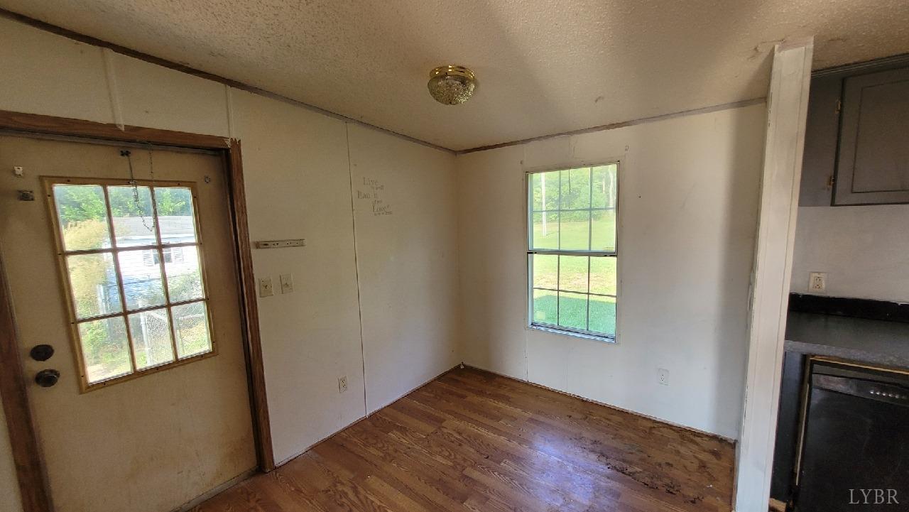 1977 Lyle Thomas Road Spout Spring, VA 24538 - Photo 5 of 11 a view of an empty room with window and wooden floor