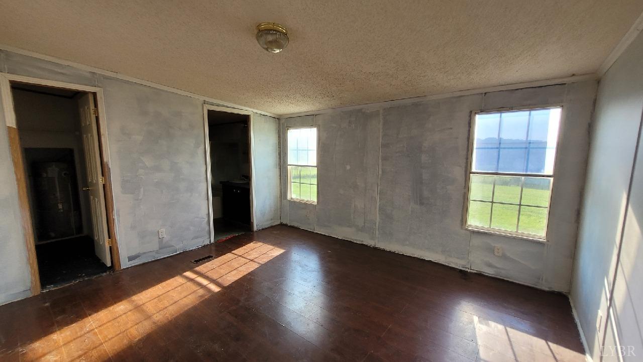 1977 Lyle Thomas Road Spout Spring, VA 24538 - Photo 6 of 11 an empty room with wooden floor and windows