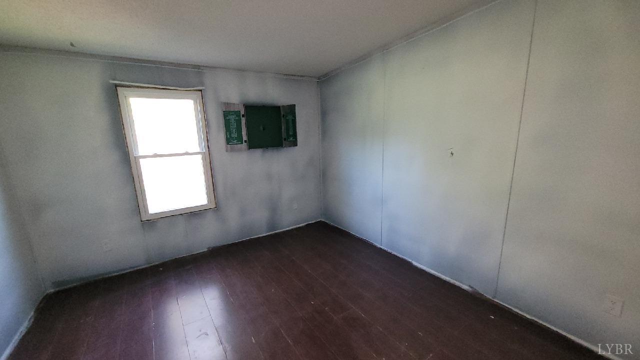 1977 Lyle Thomas Road Spout Spring, VA 24538 - Photo 10 of 11 an empty room with wooden floor and windows
