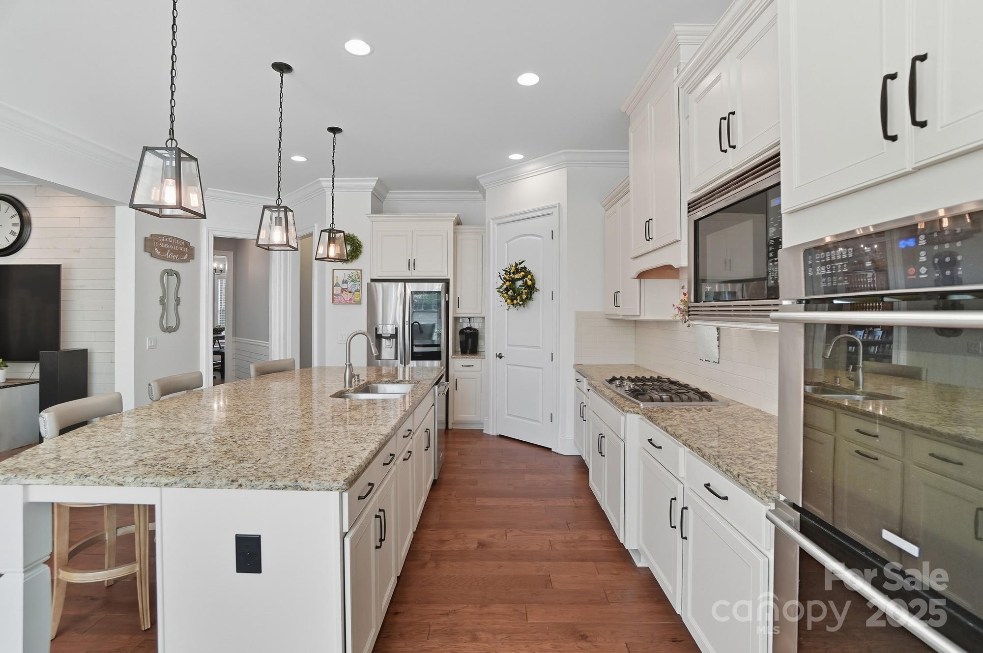 546 Abelia Lane Fort Mill, SC 29708 - Photo 13 of 43 a kitchen with stainless steel appliances granite countertop a sink a stove and a wooden floors