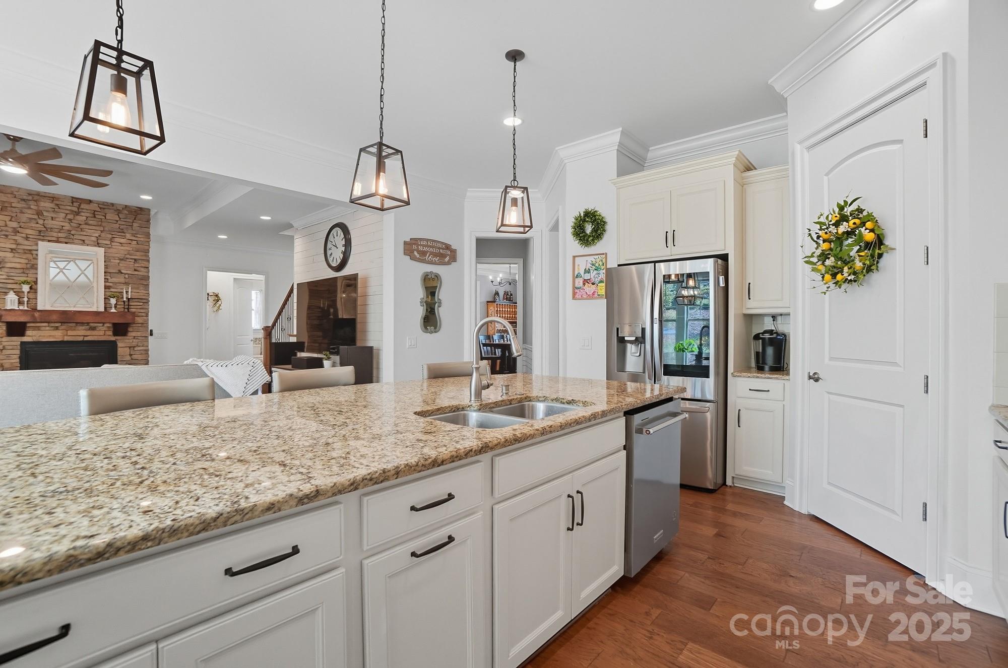 546 Abelia Lane Fort Mill, SC 29708 - Photo 16 of 43 a view of a kitchen with center island and wooden floor