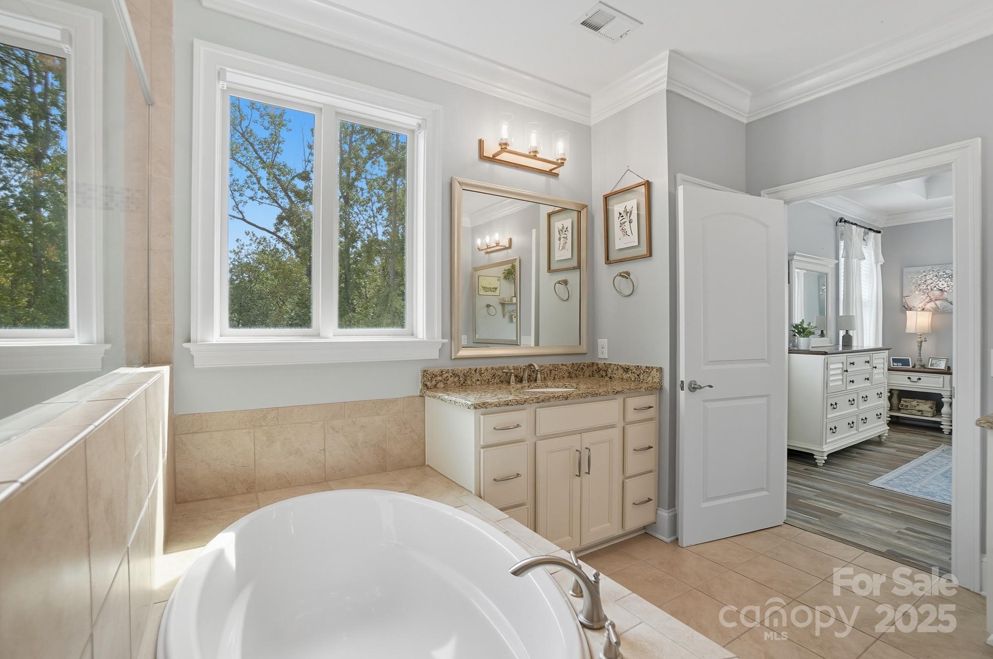 546 Abelia Lane Fort Mill, SC 29708 - Photo 24 of 43 a spacious bathroom with a granite countertop tub sink and mirror