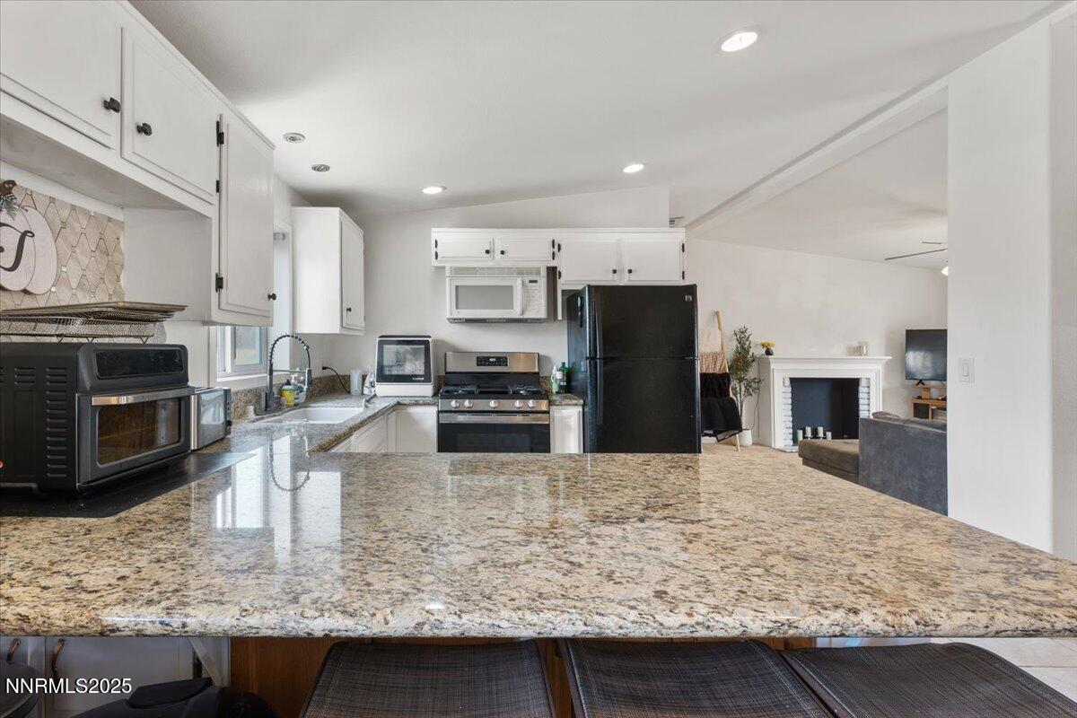17570 Thrush Lane Reno, NV 89508 - Photo 13 of 30 a kitchen with kitchen island granite countertop a sink counter top stainless steel appliances and cabinets