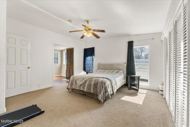 a spacious bedroom with a bed and a chandelier