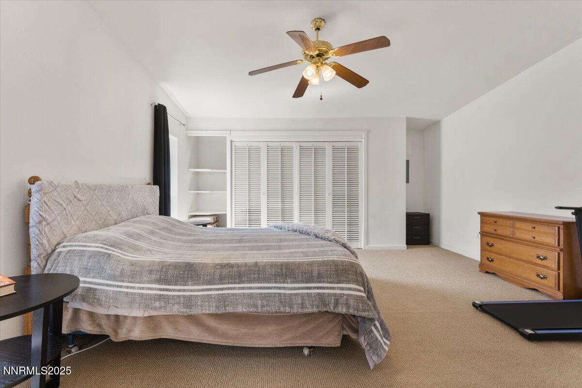 17570 Thrush Lane Reno, NV 89508 - Photo 15 of 30 a bedroom with a bed and a chandelier