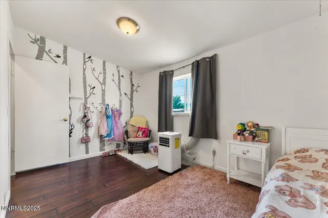 a bedroom with furniture and a window