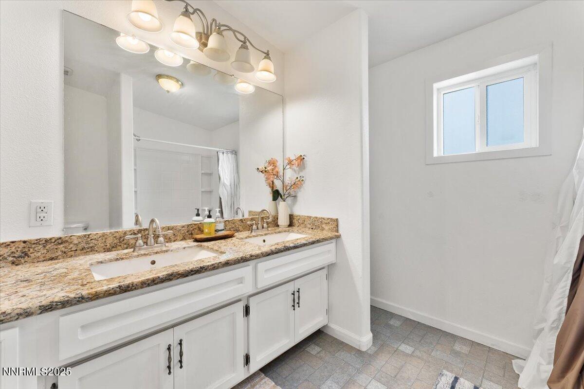 17570 Thrush Lane Reno, NV 89508 - Photo 24 of 30 a bathroom with a granite countertop sink and a mirror