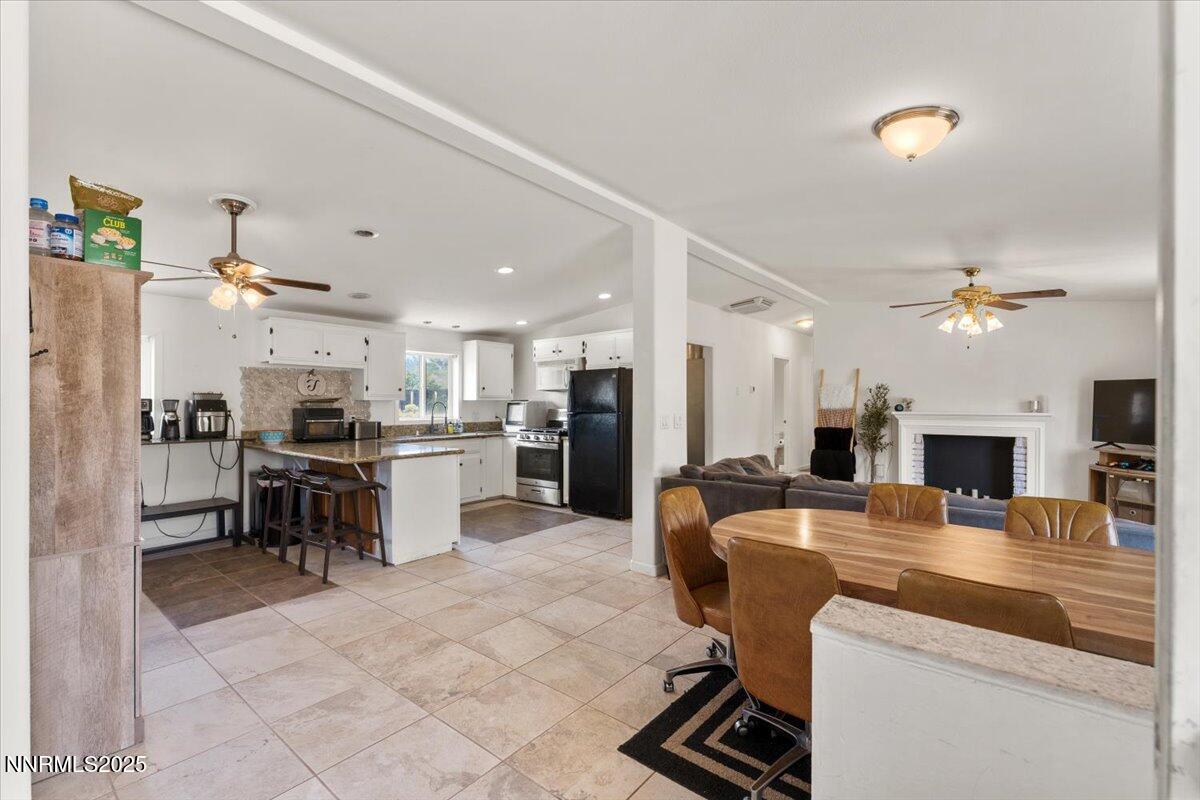 17570 Thrush Lane Reno, NV 89508 - Photo 4 of 30 a kitchen with kitchen island a refrigerator and a stove top oven