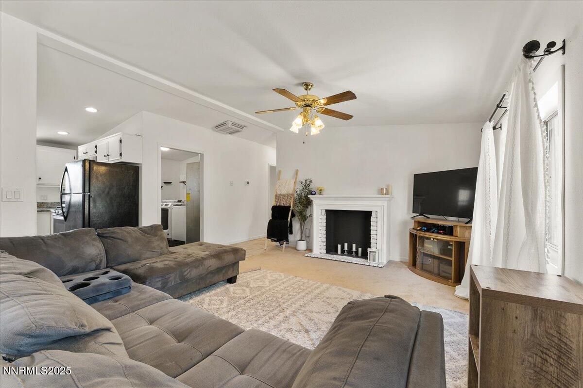 17570 Thrush Lane Reno, NV 89508 - Photo 7 of 30 a living room with furniture a fireplace and a flat screen tv