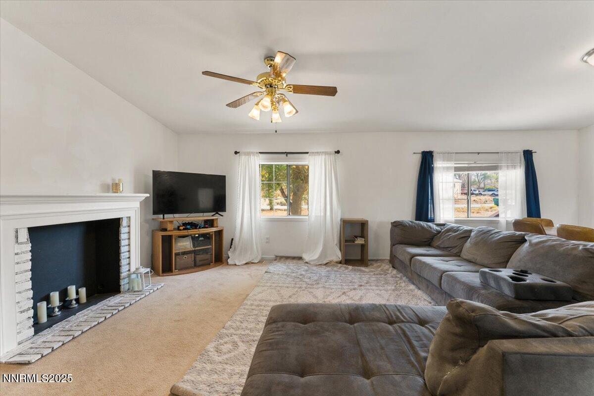 17570 Thrush Lane Reno, NV 89508 - Photo 8 of 30 a living room with furniture a fireplace and a flat screen tv