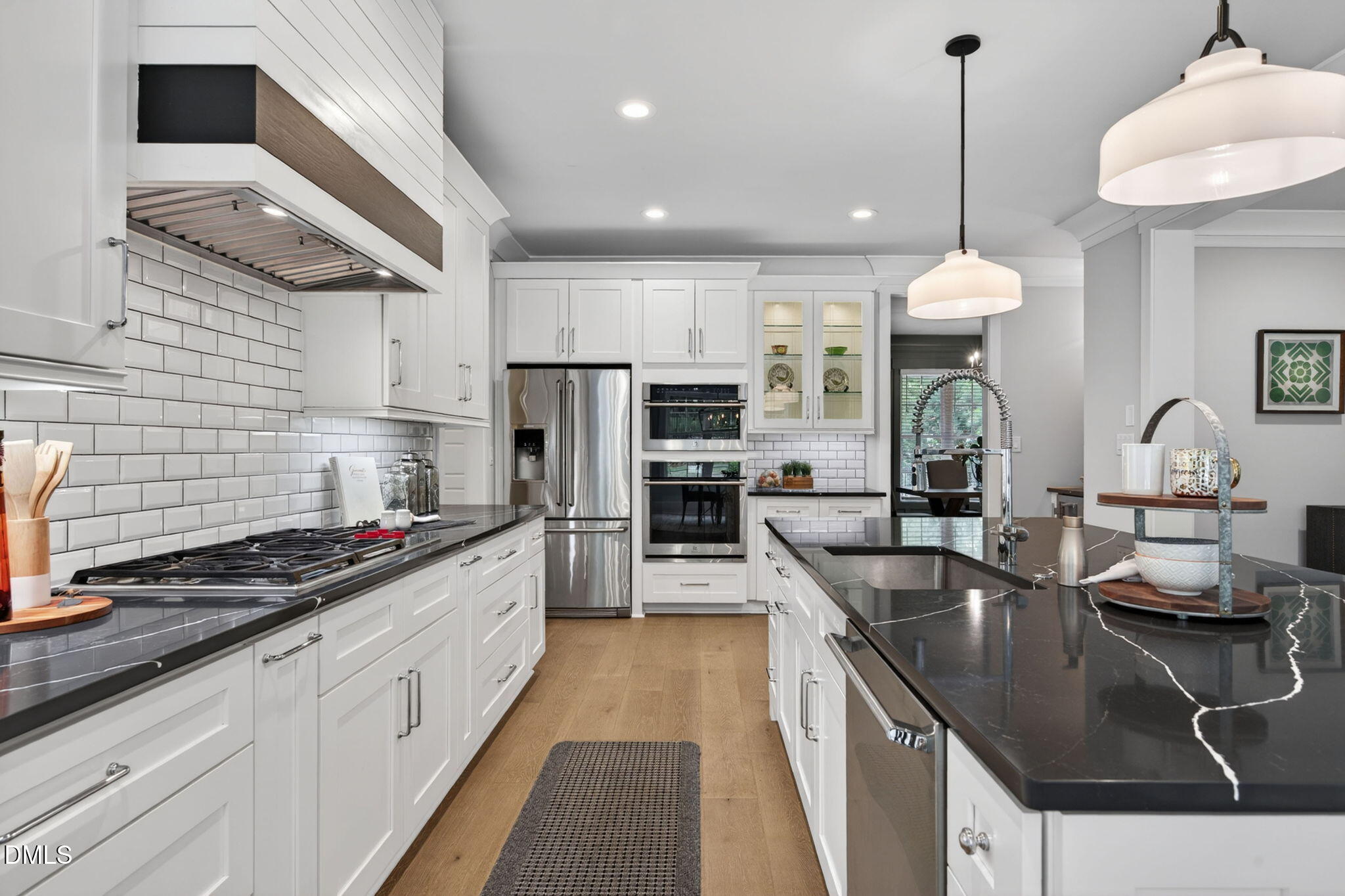 3417 Edgemont Drive Raleigh, NC 27612 - Photo 23 of 83 a kitchen with stainless steel appliances granite countertop a sink a stove and a wooden cabinets
