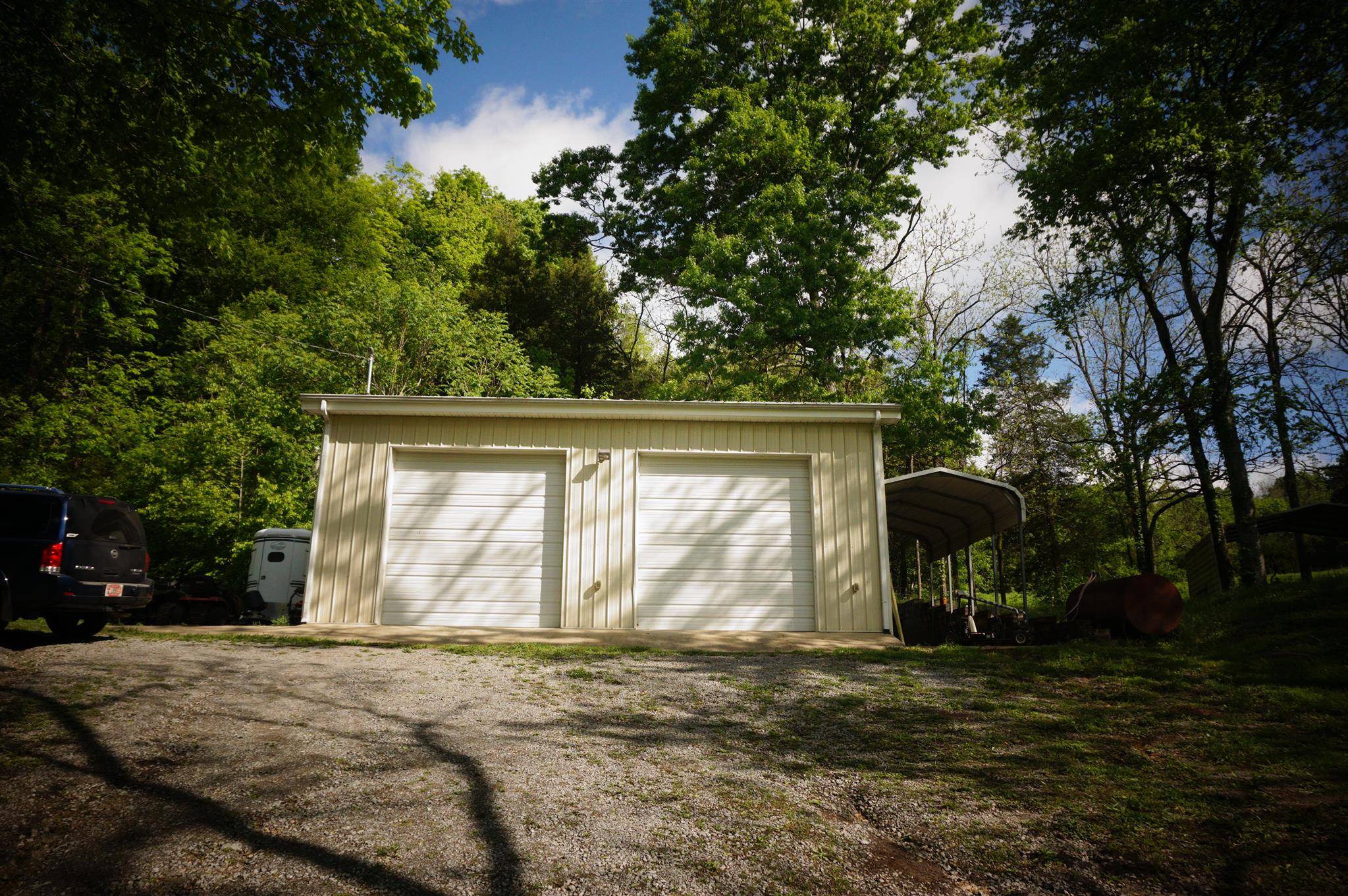171 Poorhouse Road Taft, TN 38488 - Photo 6 of 27 a front view of a house with garden