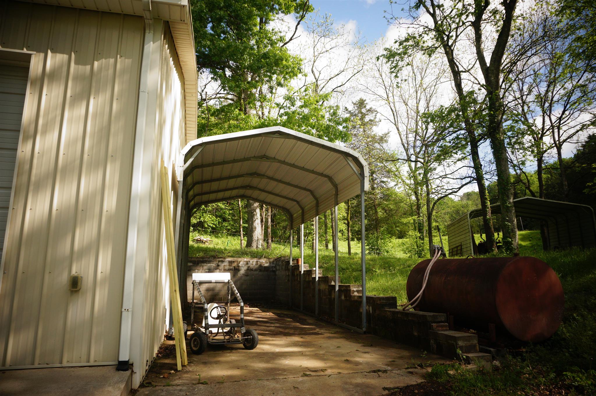 171 Poorhouse Road Taft, TN 38488 - Photo 7 of 27 a view of backyard with barbeque grill and outdoor seating